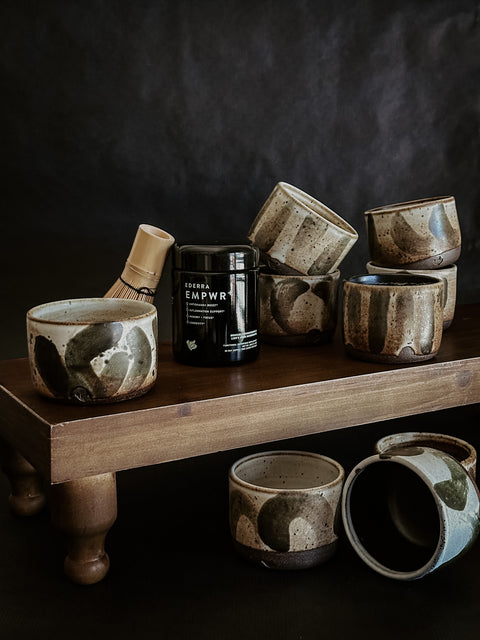 Many LURRA ceramic cups with EMPWR+ Jar and a whisk