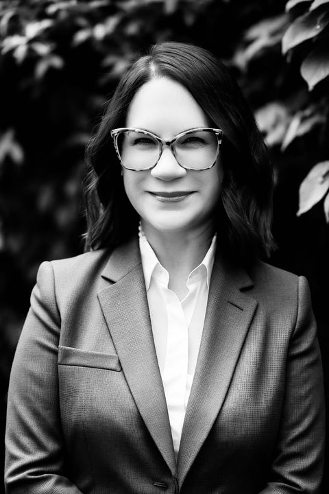 black and white photo of EDERRA Marketing brand advisor Renee Beall, MBA in a suit jacket looking at the camera