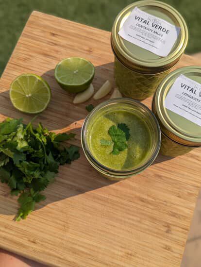 Jar of green sauce called vital verdefrom meal prep company salt and soil